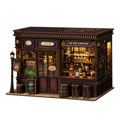 Miniature corner tavern with lit interior bar, bottles, and front door windows