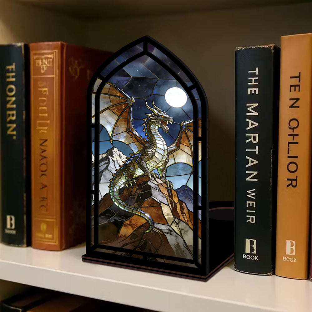 Arched stained-glass dragon display stand with black frame and glowing candle light