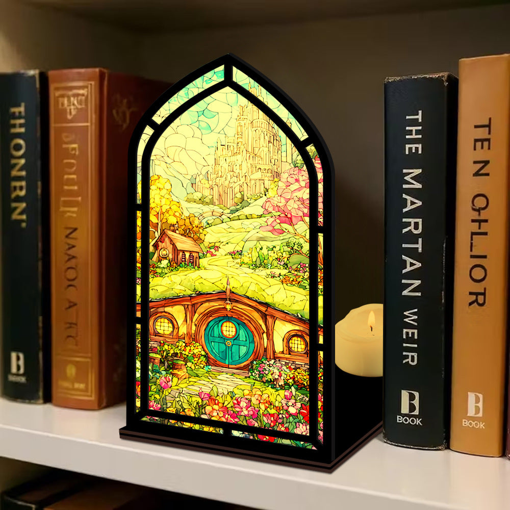 Arched book nook display with colorful illustrated panel, with books beside it on a shelf.