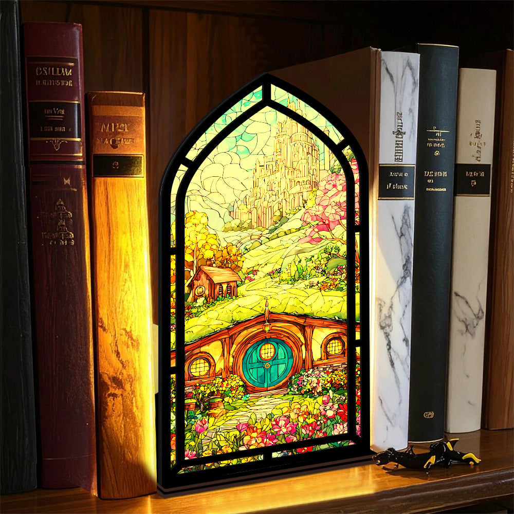 Arched book nook display with lit interior glow and colorful illustrated panel on a shelf.