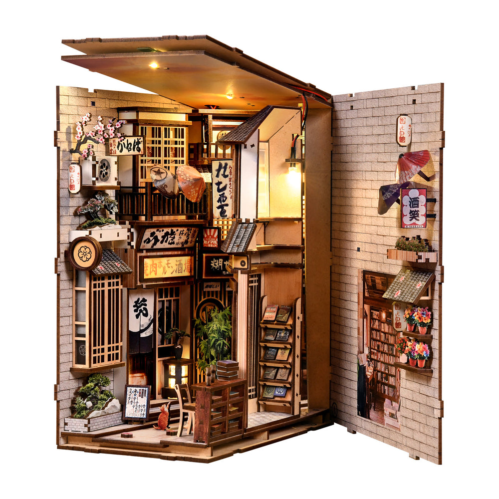 DIY book nook kit: folded display showing detailed storefronts, shelves, and lantern light