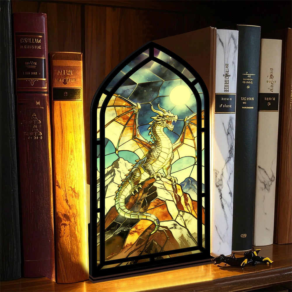 Arched stained-glass dragon stand with black frame and lit candle light