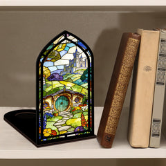 Book nook display with stained-glass style panel beside books on a shelf