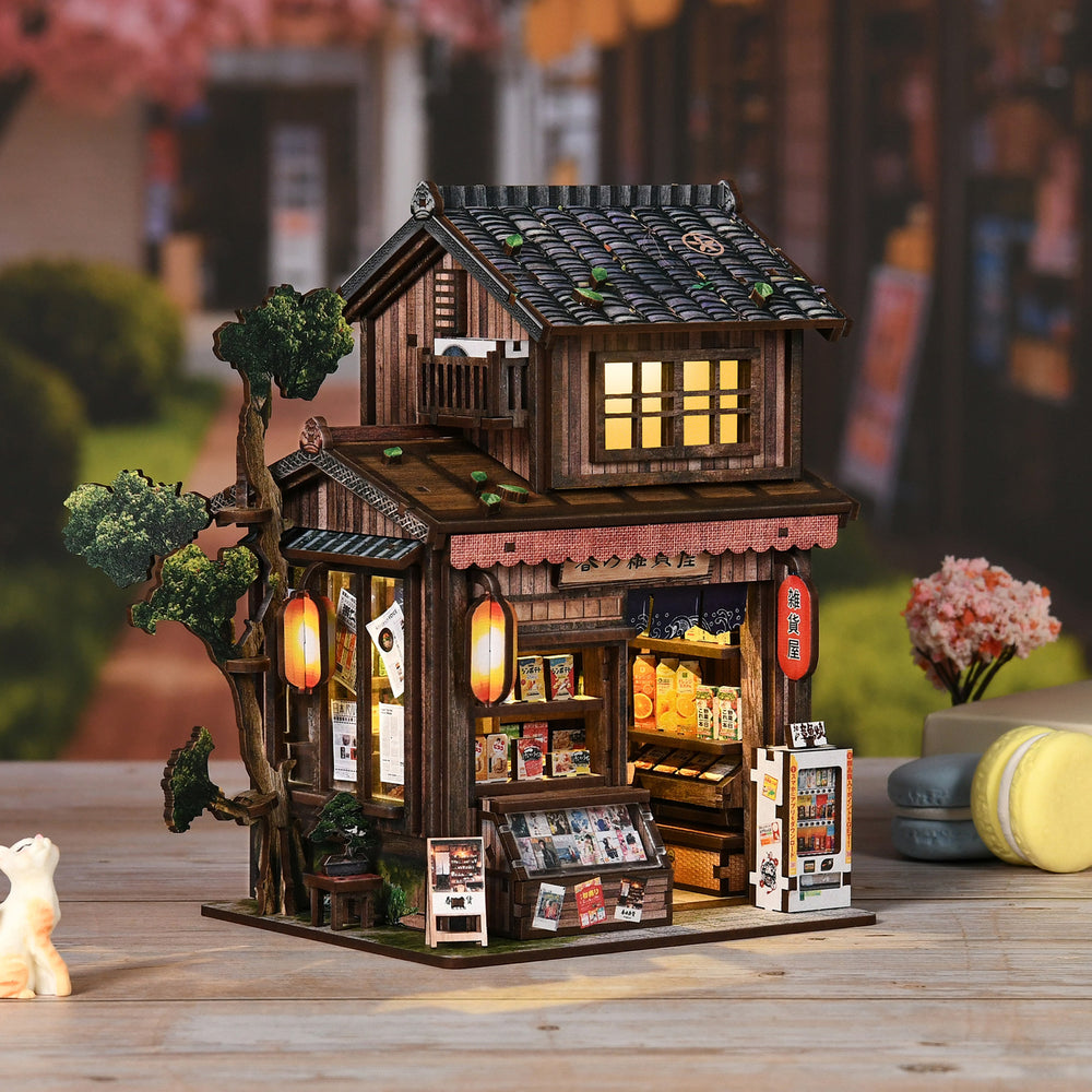 Illuminated miniature wooden grocery store with tiled roof and open front display shelves