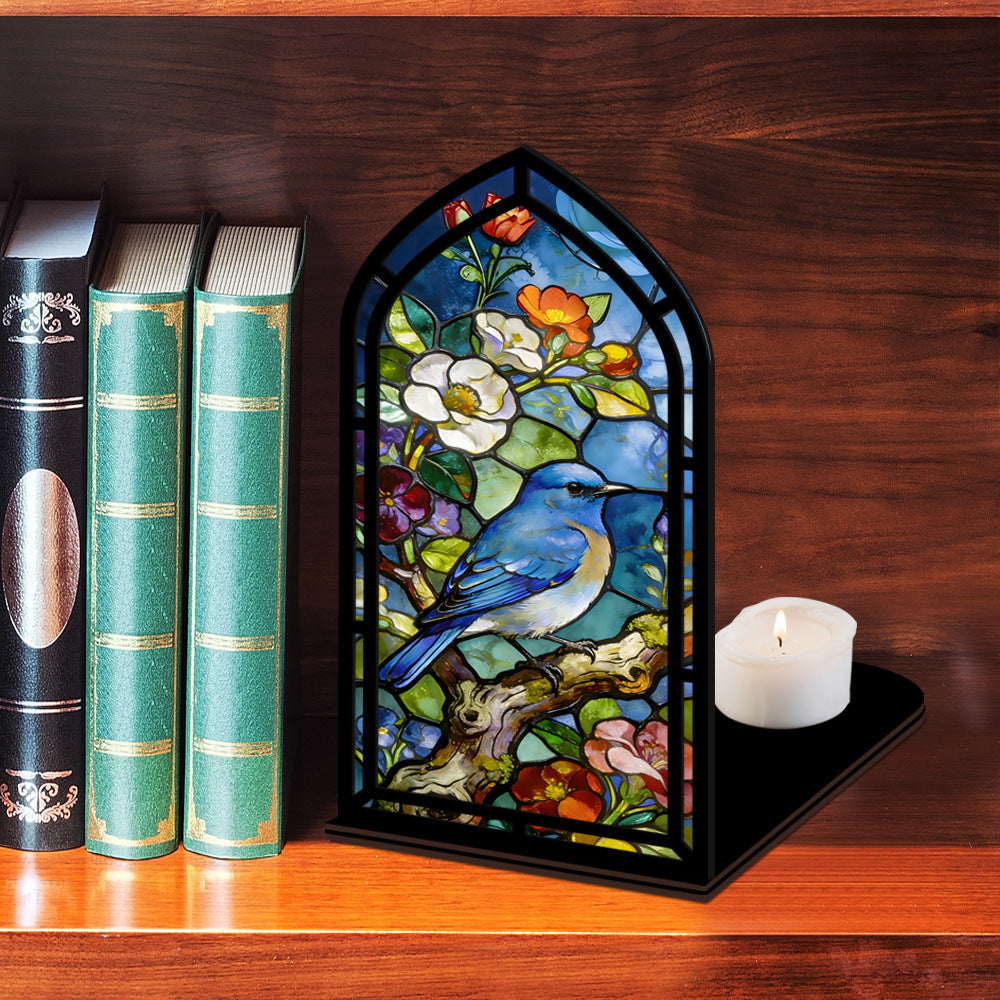 Arched bluebird stained-glass book nook with black frame and candle on base tray