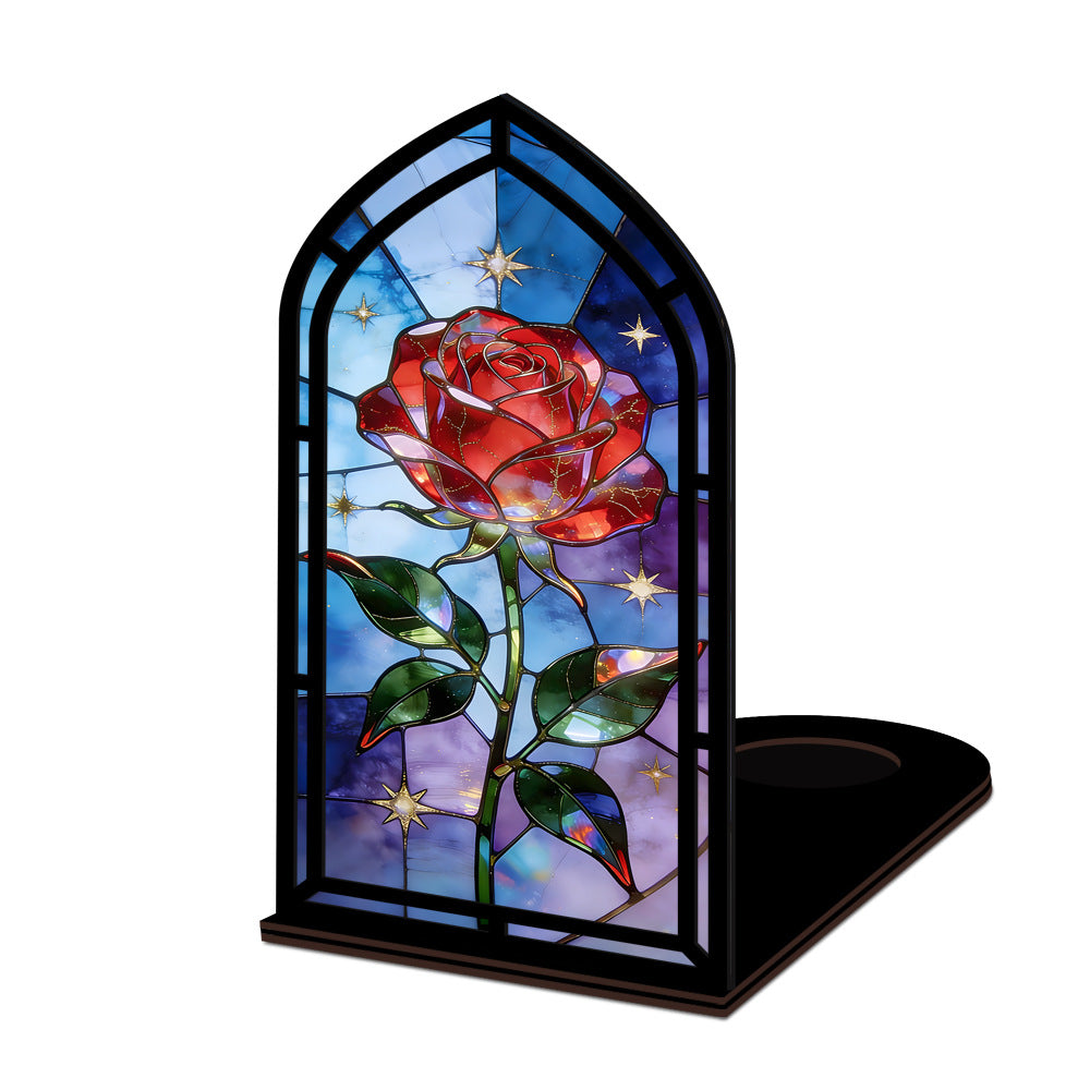Black arched book nook with stained-glass red rose, candle base on the right