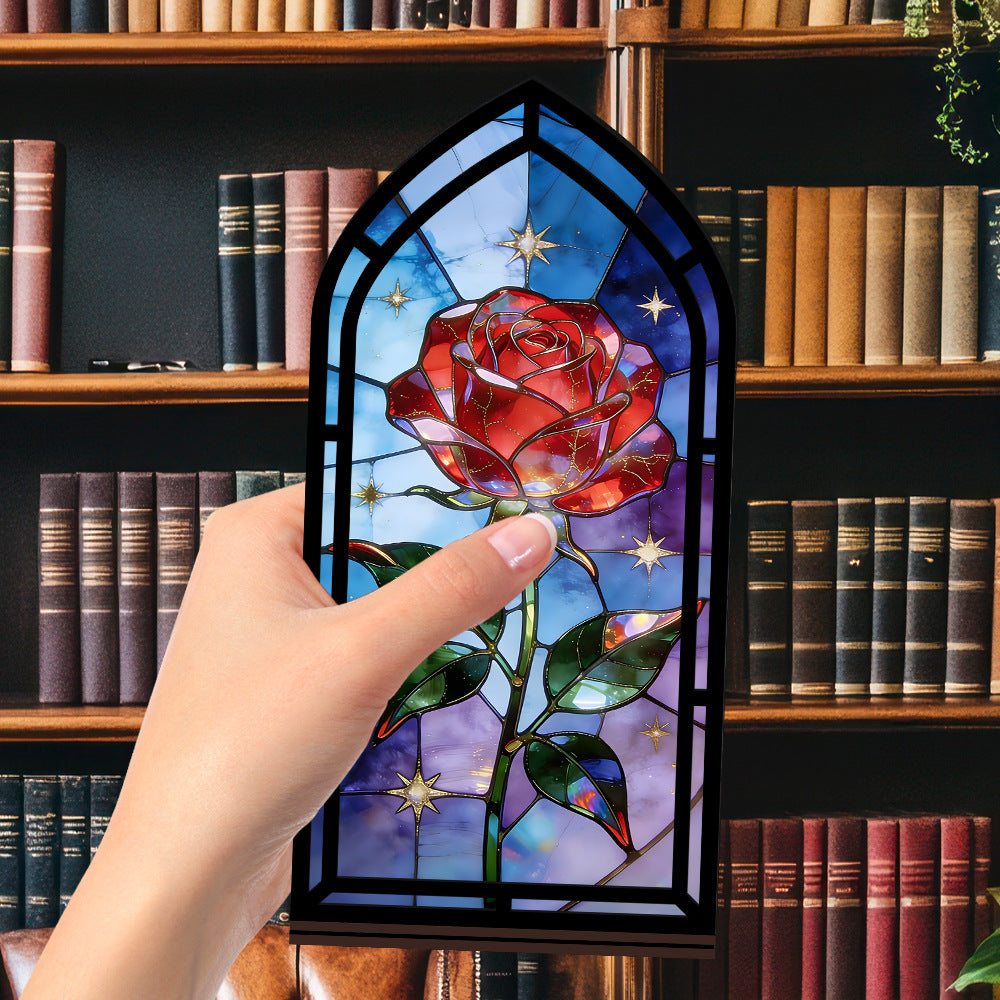 Stained-glass red rose arched book nook, close view with a hand touching the glass