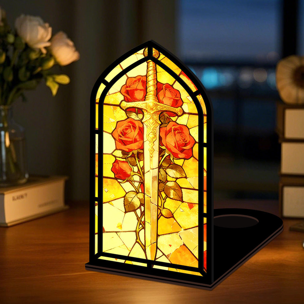 Arched stained-glass book nook with glowing candle light, sword and red roses