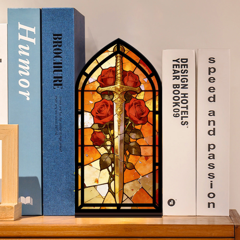 Book nook with arched stained-glass sword design and red roses, black frame