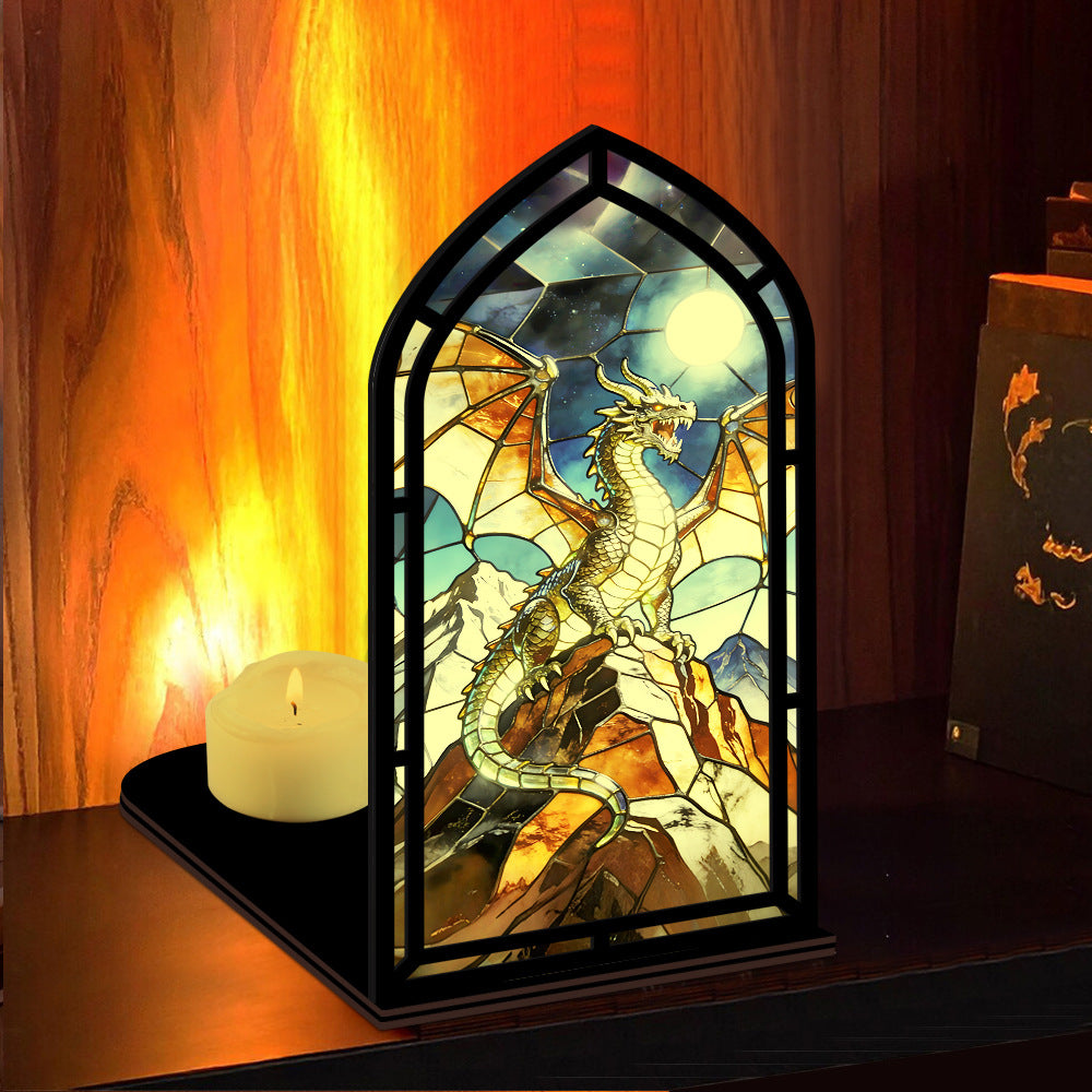 Arched stained-glass dragon stand with black frame and lit candle on shelf