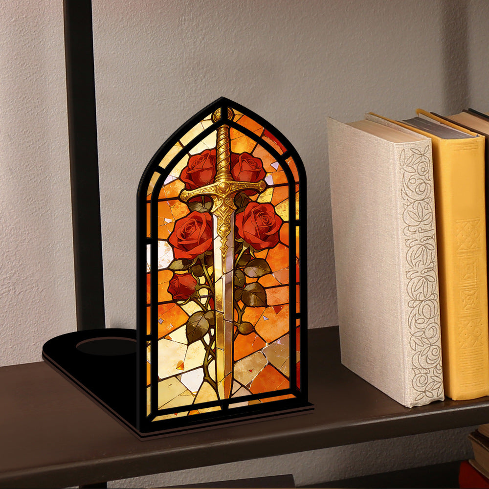 Arched stained-glass book nook on tabletop, sword and red roses, black frame