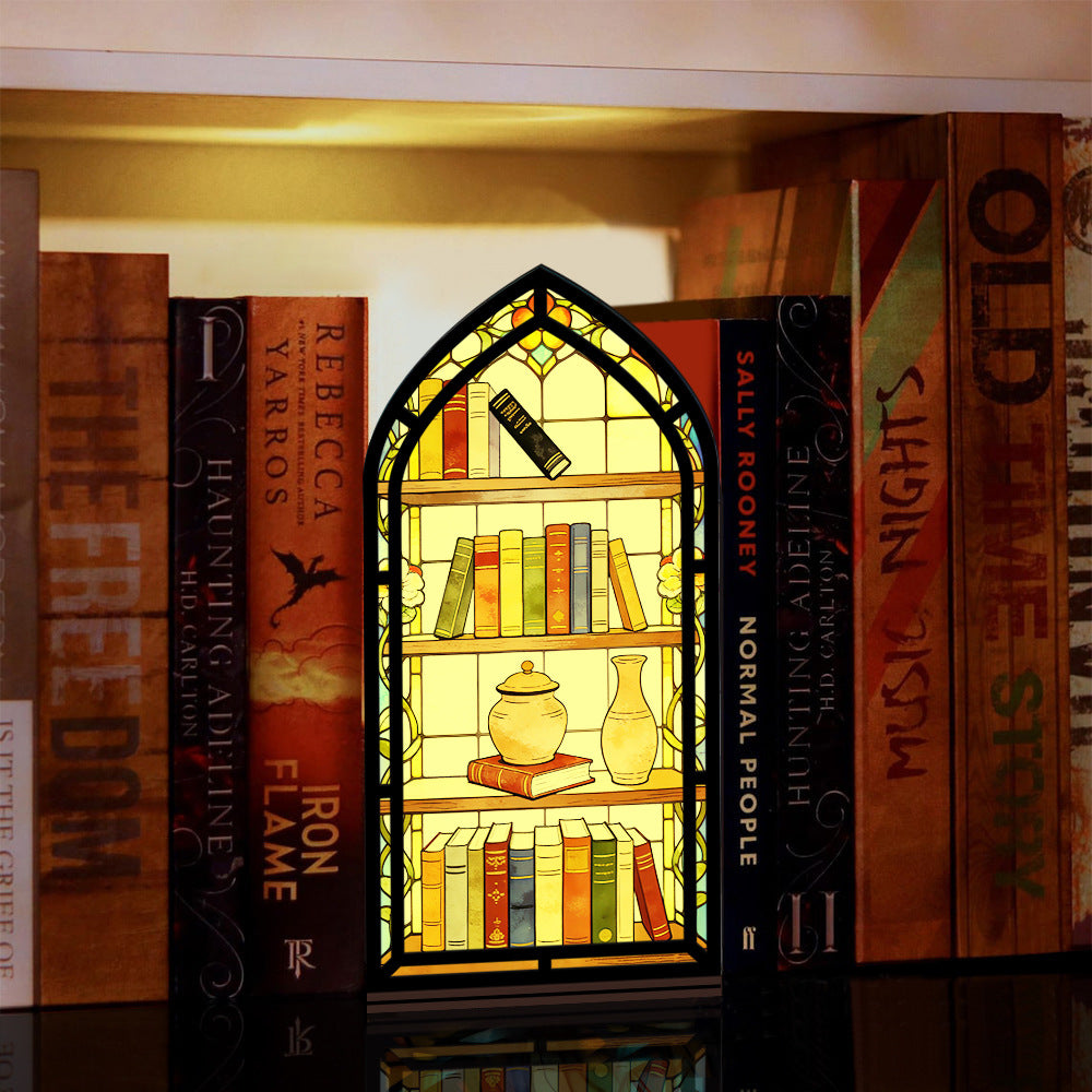 Arched illuminated book nook display with faux books, vase, and candle-glow shelf panel.