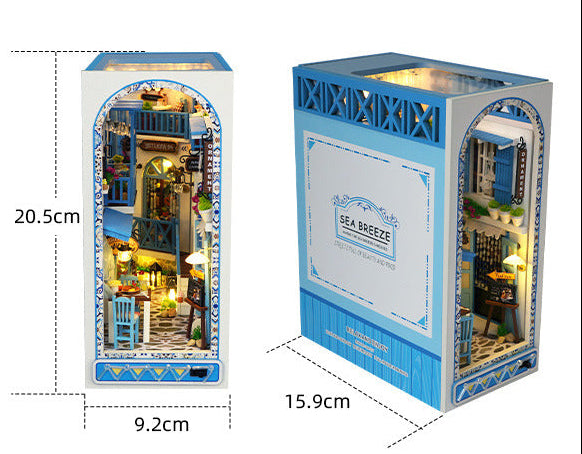 Book nook kit packaging with size diagram and arched front window showing lit room