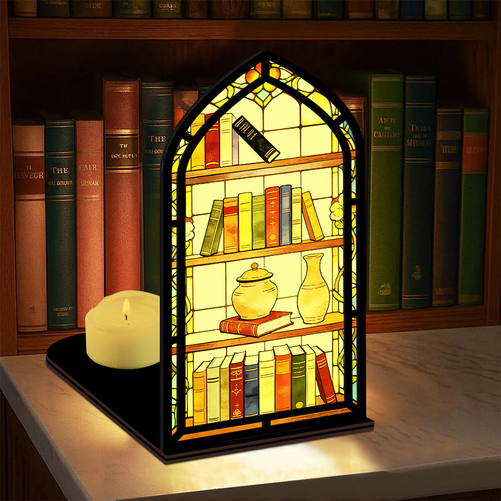 Arched illuminated book nook with faux books and candle-glow panel on a shelf.