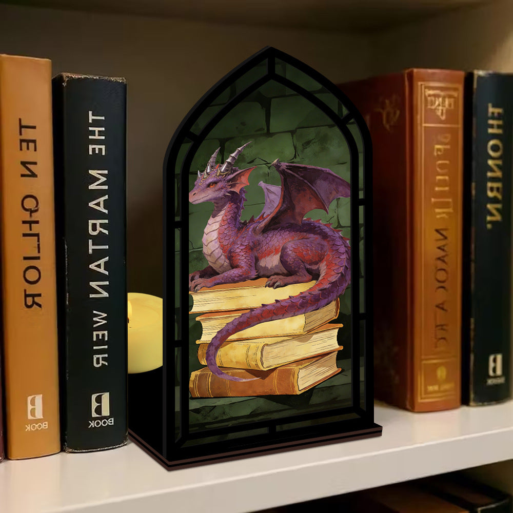 Dragon book nook on shelf: black arched frame with purple dragon and stacked books display