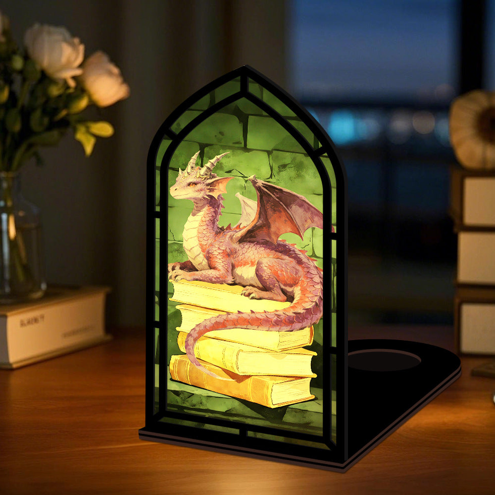 Candle-glow dragon book nook: black arched frame with purple dragon on stacked books