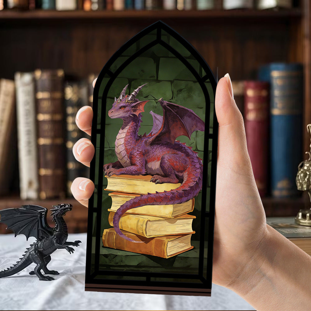 Dragon book nook stand with arched black frame and purple dragon resting on stacked books