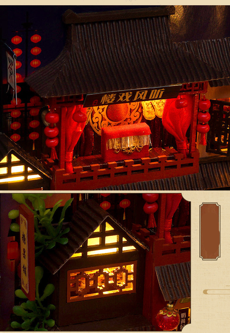 Miniature book nook kit close-up of red lanterns, decorative awning, and glowing storefront window