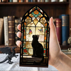 Hand holding a stained glass arched book nook with black cat silhouette and butterfly details