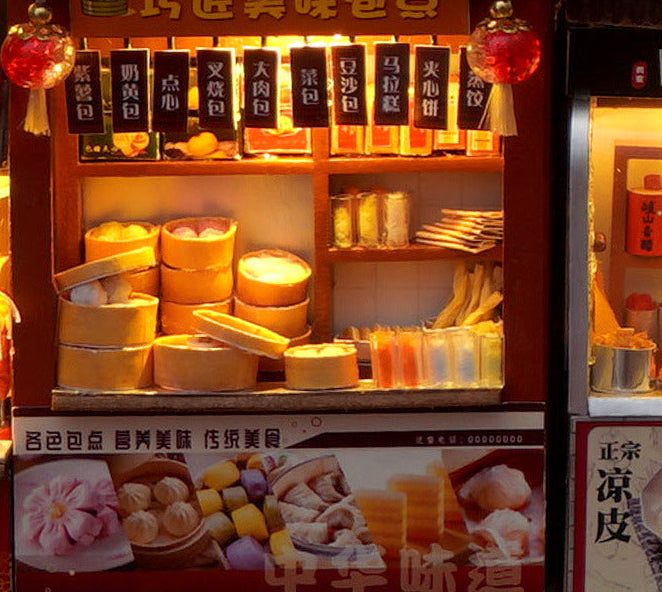 Miniature book nook kit close-up of illuminated snack shelf with wrapped items and small jars