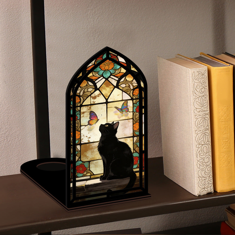 Stained glass arched book nook on shelf with black cat silhouette and butterfly window glow