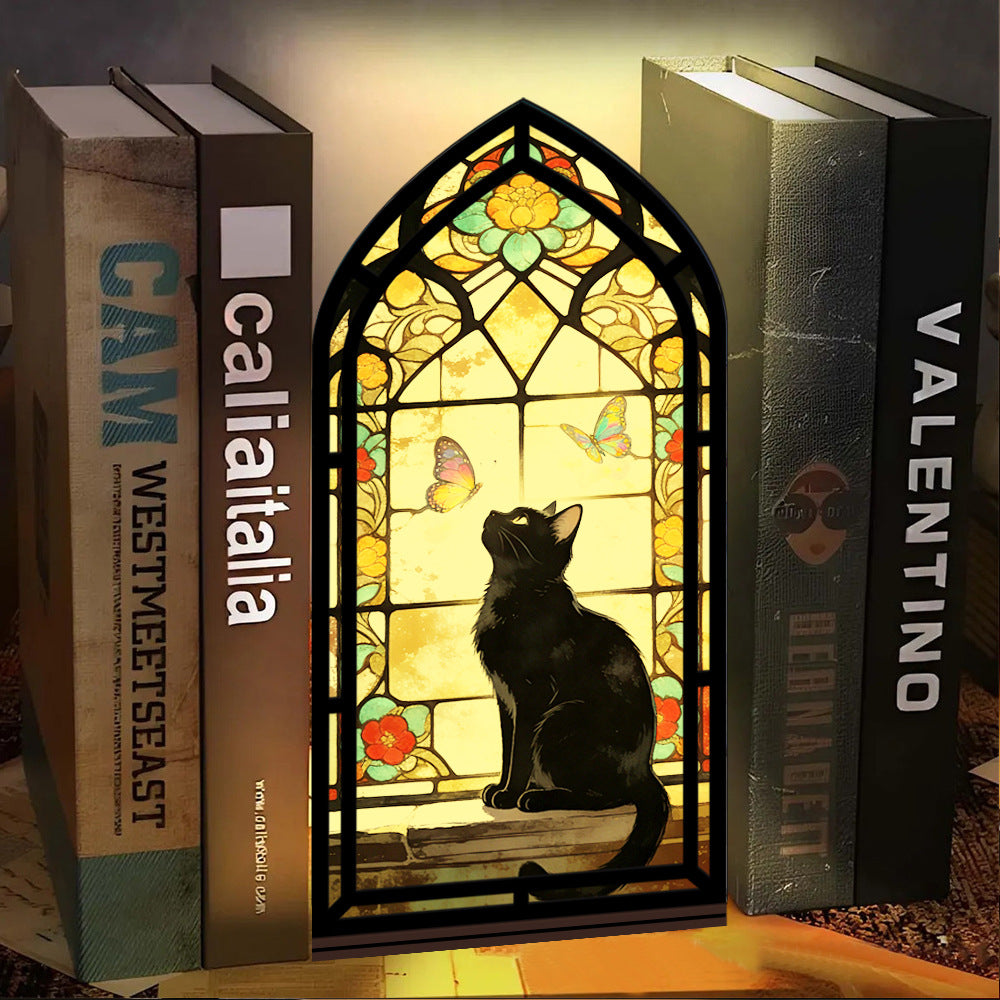 Stained glass arched book nook with black cat silhouette and butterfly window glow