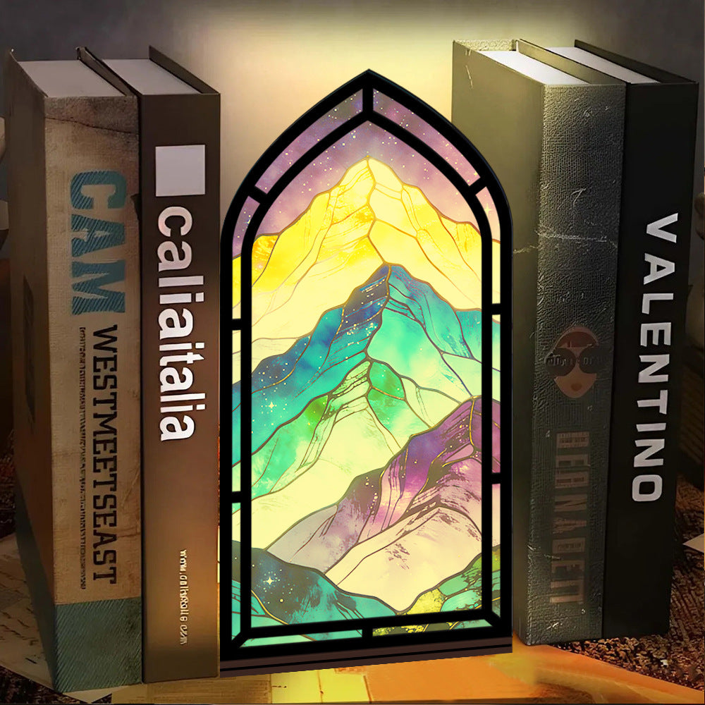 Arched glowing mountain panel book nook with multicolor LED outline on shelf