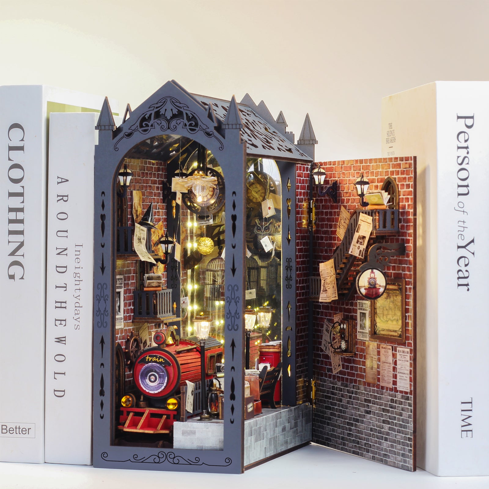 Miniature train book nook kit with red toy train and lit brick diorama display