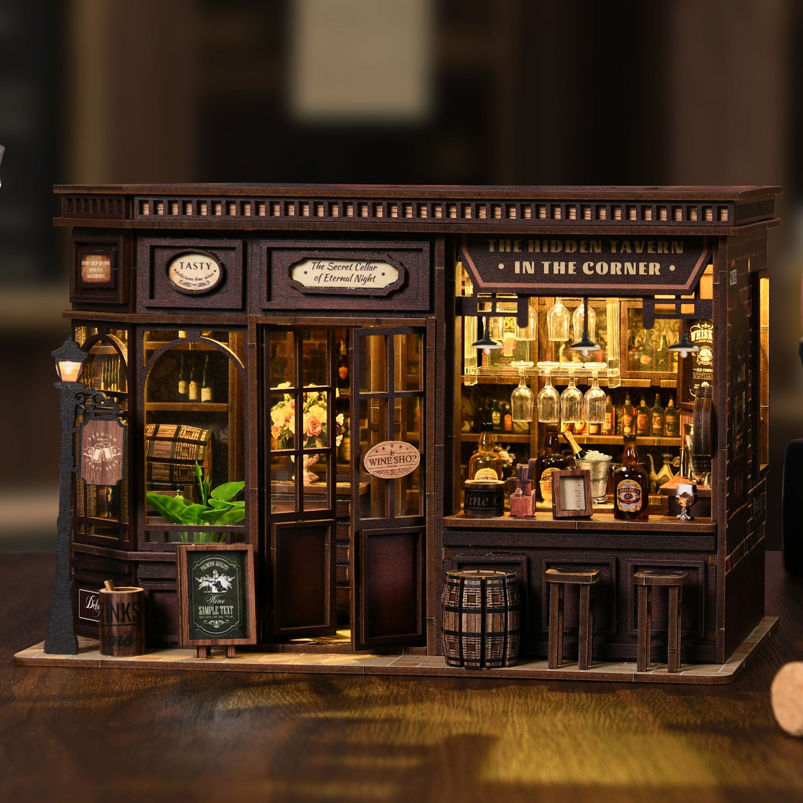 Miniature corner tavern model with glowing bar shelves, bottles, and front door