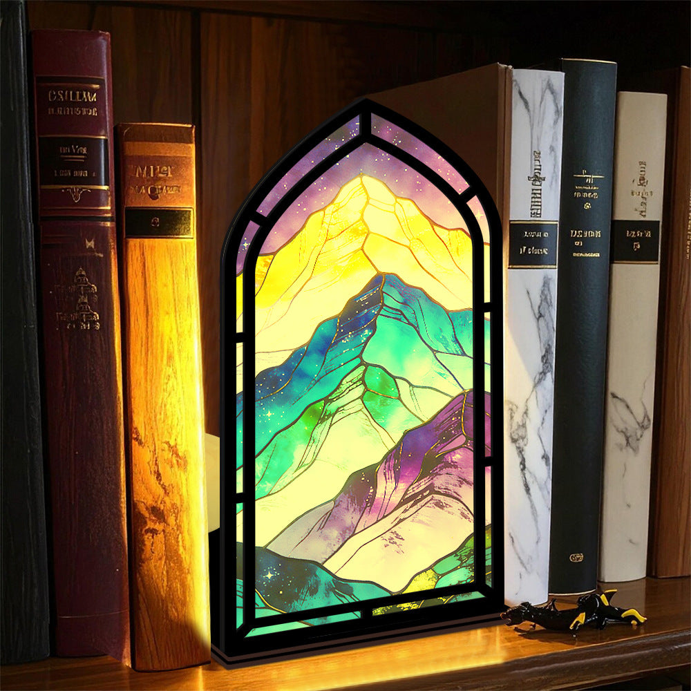 Arched glowing mountain book nook display with multicolor LED border on bookshelf
