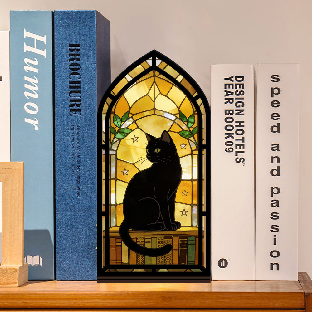 Arched black cat book nook with warm internal light between books
