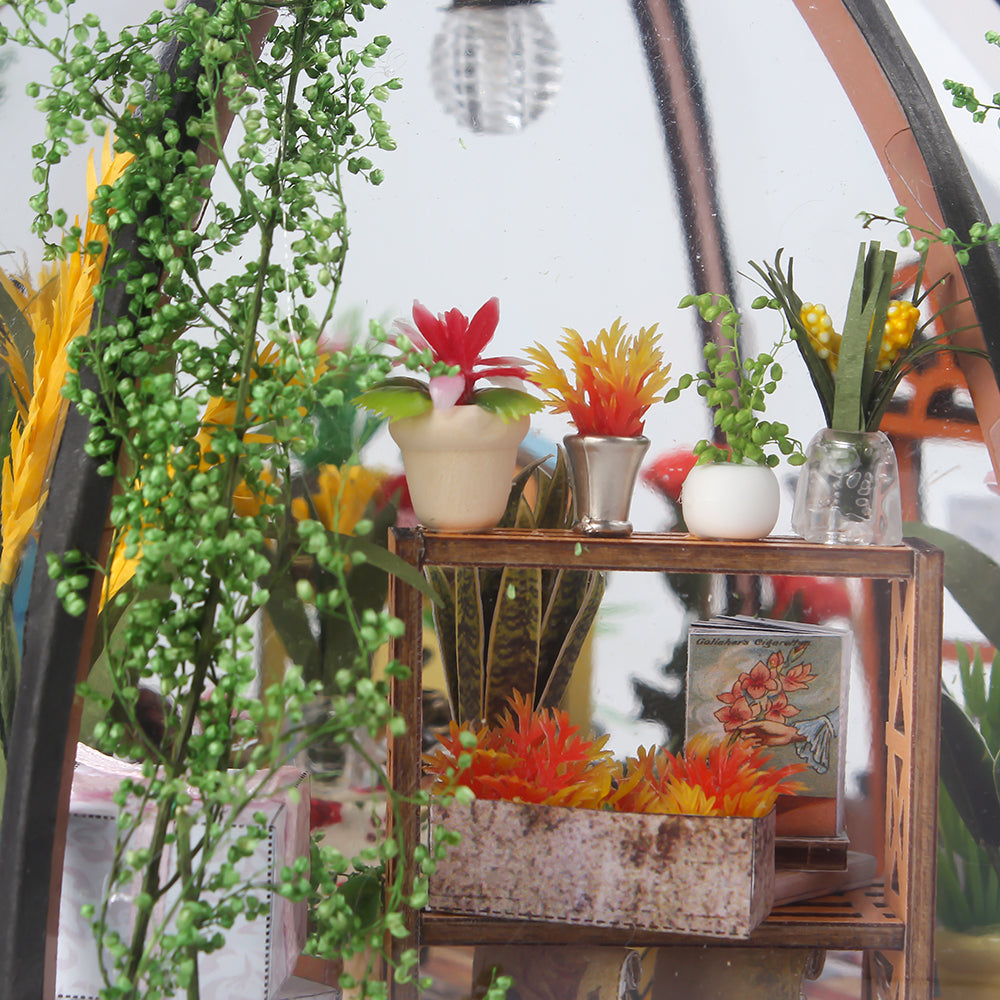 Miniature greenhouse house kit interior shelf with potted plants and colorful flowers