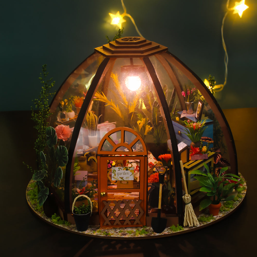 Greenhouse miniature house kit with domed glass walls and front wooden door panel.
