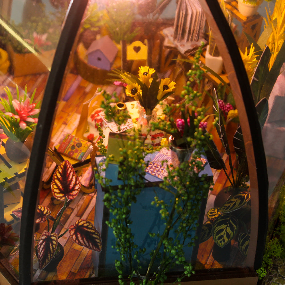 Miniature greenhouse house kit with windowed arch and dense flower and leaf miniatures inside