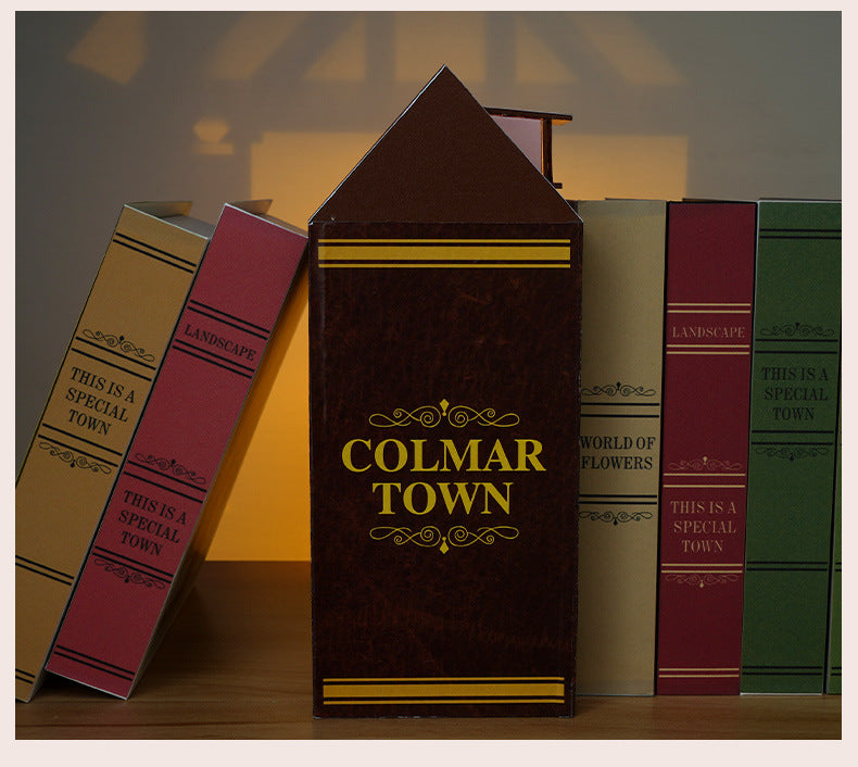 Miniature vintage books with ornate covers and gold lettering, standing book front view