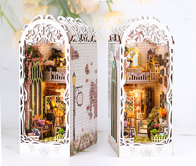 Miniature book nook kit set with two white arched panels showing lit interior garden