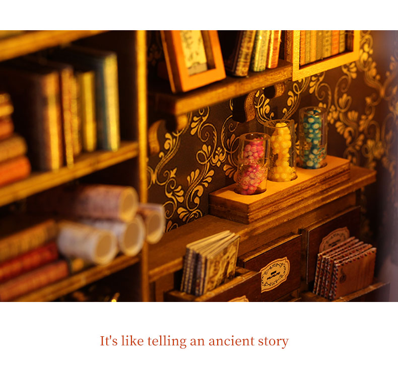 Miniature book nook shelf insert with lit candles, books, and ornate patterned backing
