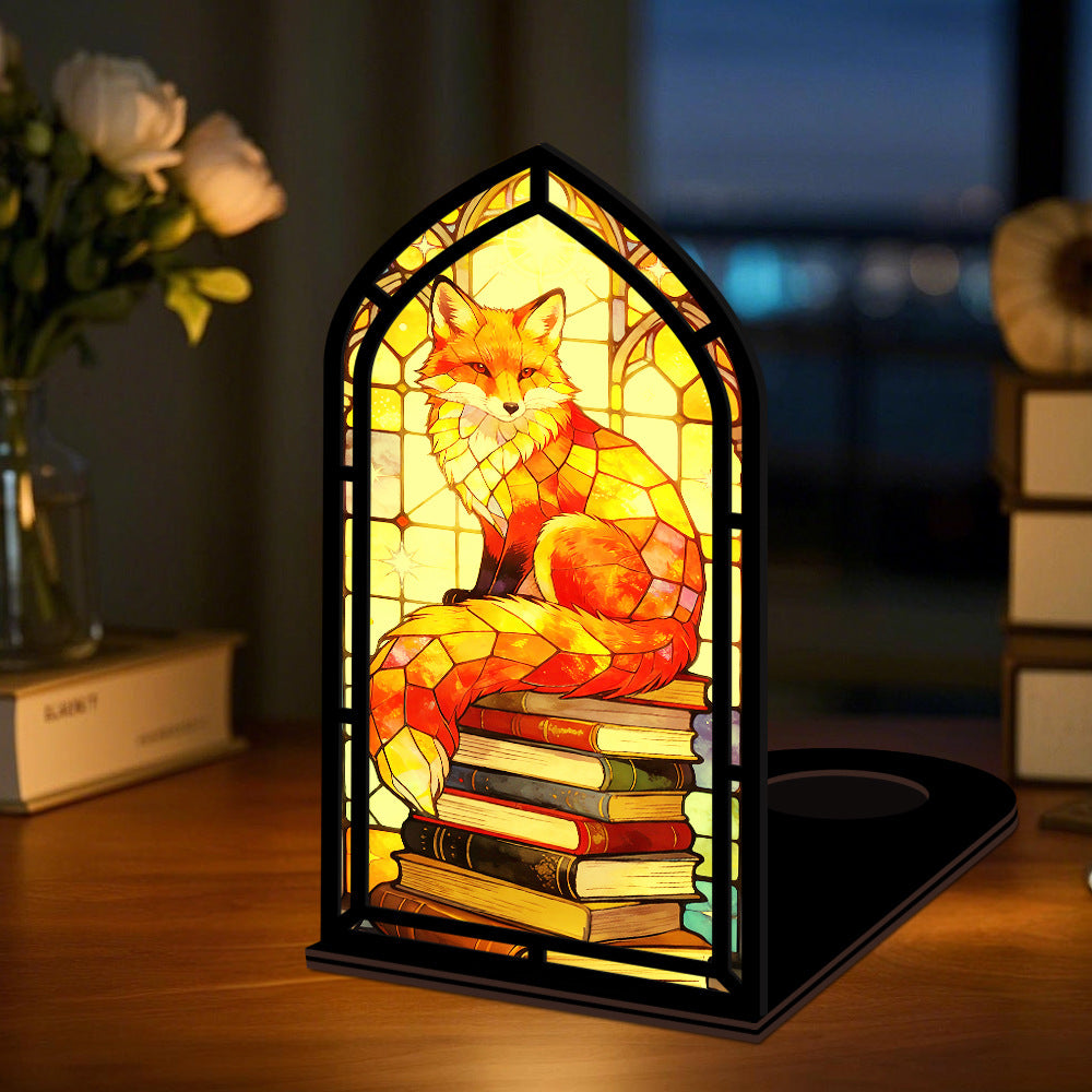 Arched fox book nook displaying stacked books with warm glowing center light