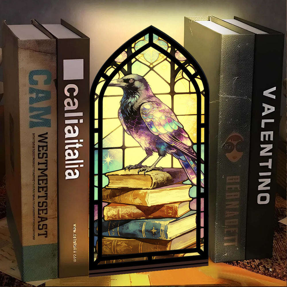 Arched book nook candle display with purple raven and stained-glass window design