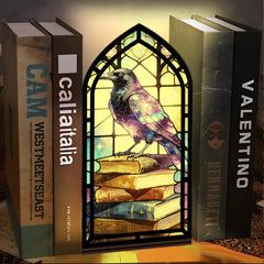 Arched book nook candle display with purple raven and stained-glass window design