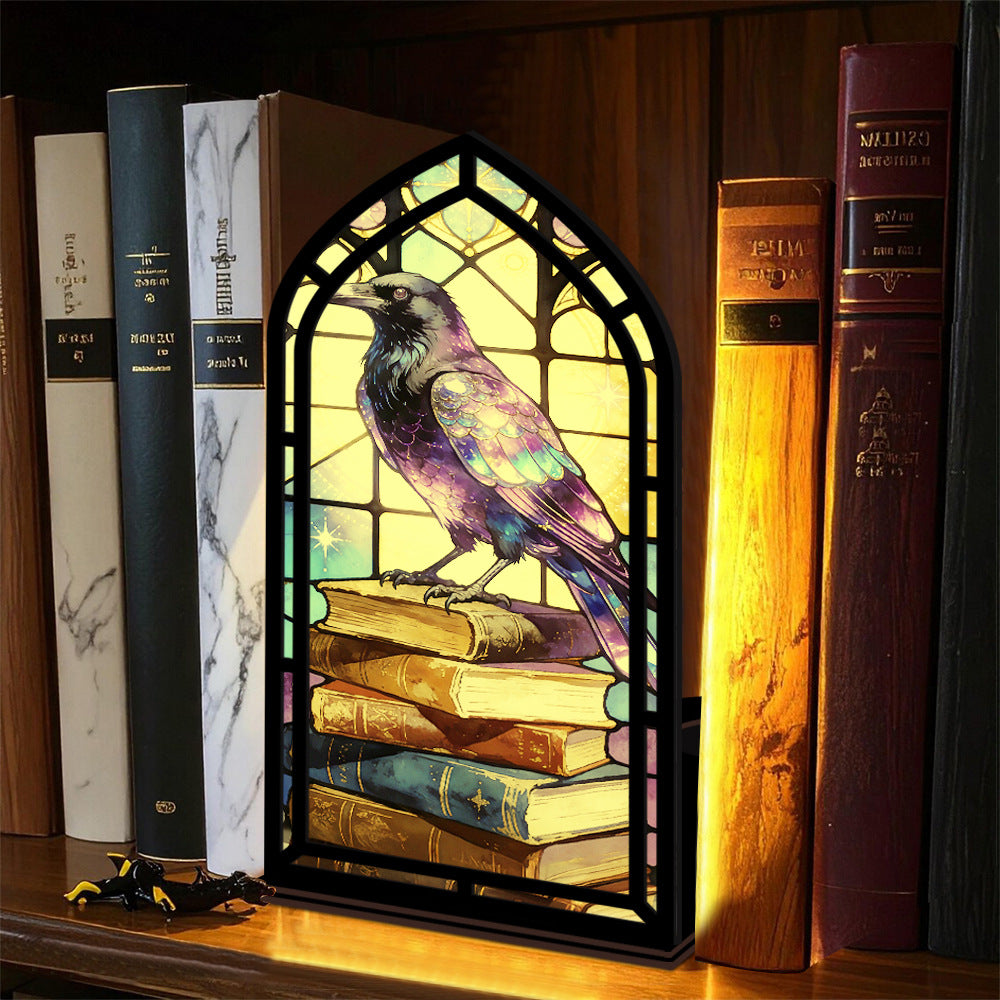 Arched book nook candle display with purple raven and dark framed window