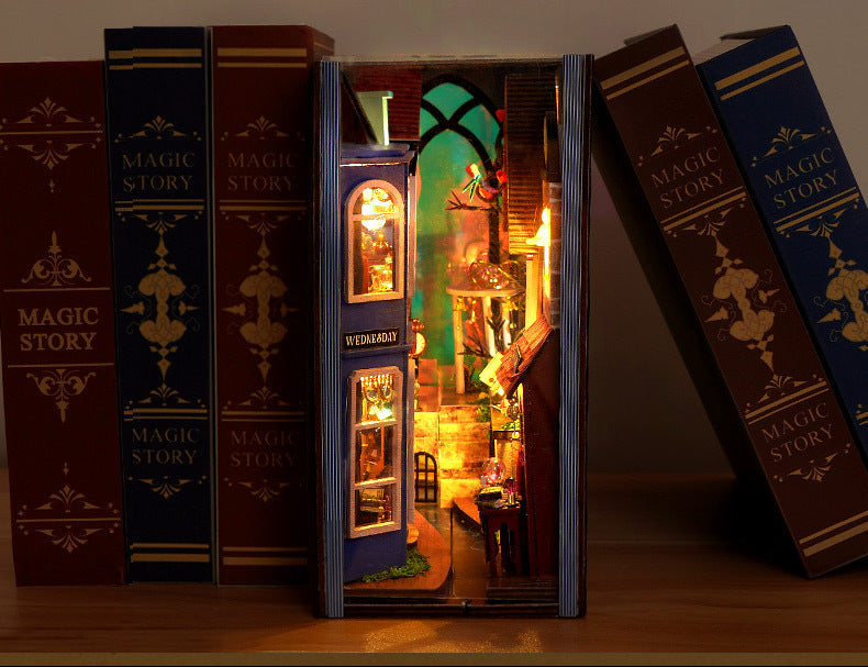 DIY book nook kit opened to show lit rooms, doors, and small furniture details
