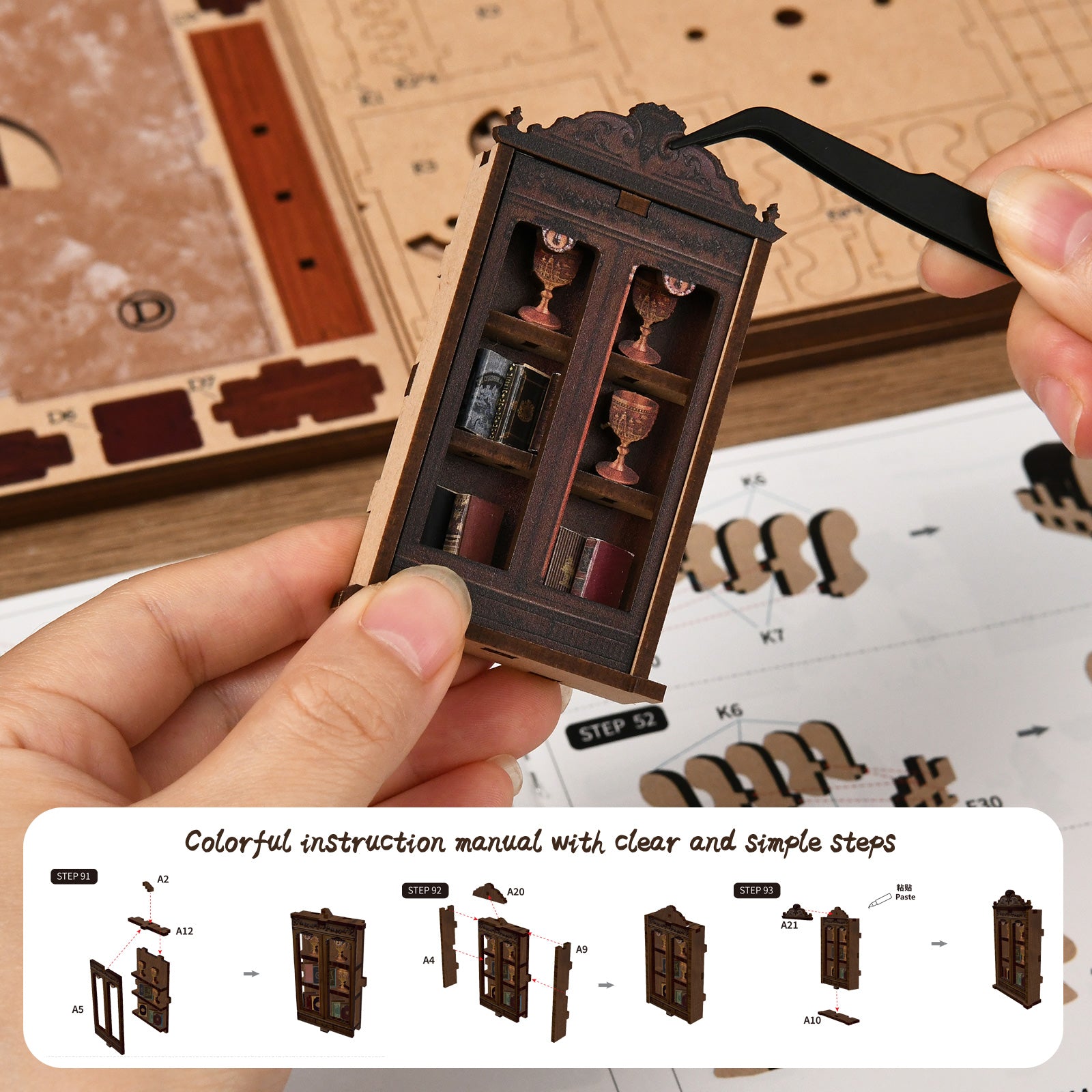 DIY miniatures kit manual and hands holding a small wooden cabinet piece