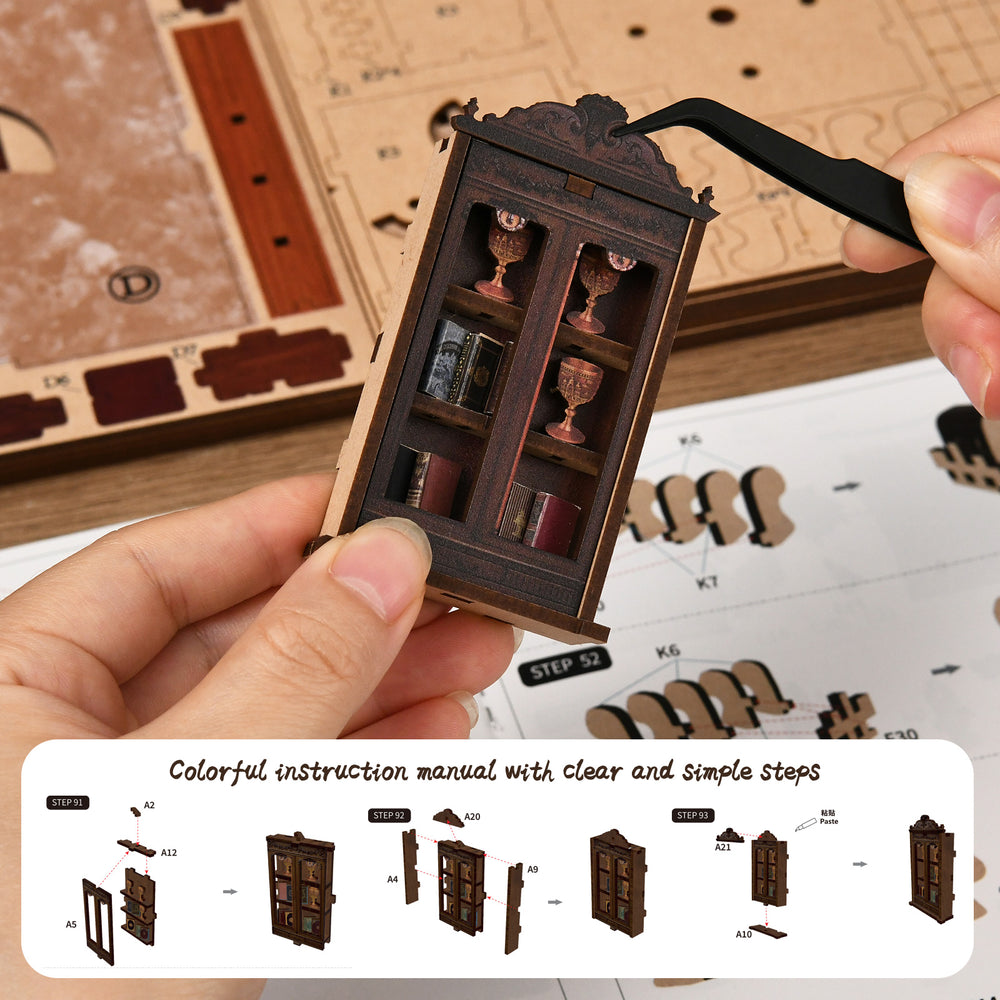 DIY miniatures kit manual and hands holding a small wooden cabinet piece