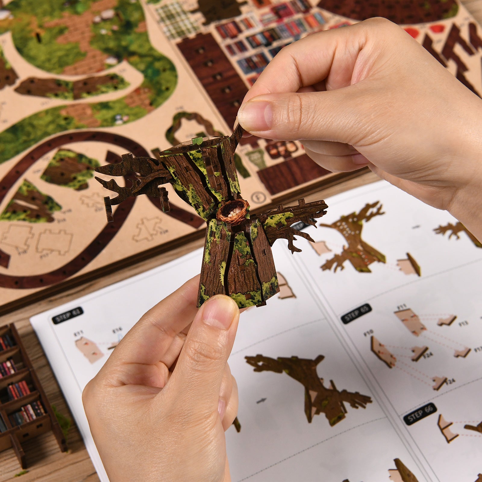 Hands assembling DIY miniature treehouse parts with small wooden sections