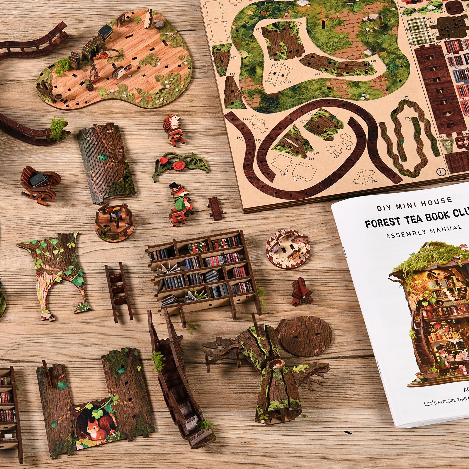 DIY miniature treehouse kit pieces and instruction booklet on wooden tabletop