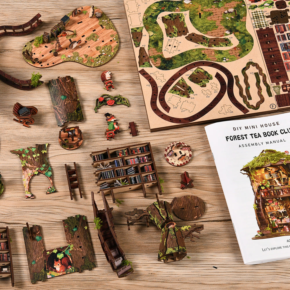 DIY miniature treehouse kit pieces and instruction booklet on wooden tabletop