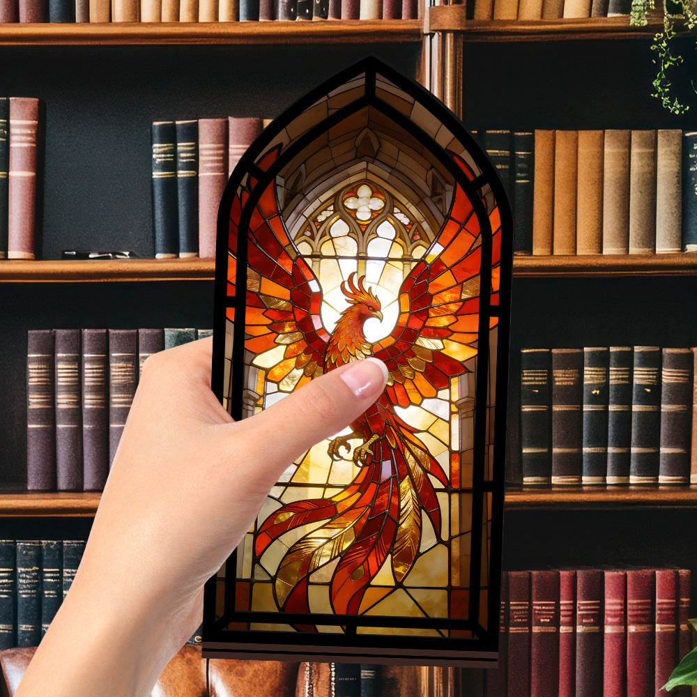 Stained-glass phoenix firebird display with glowing phoenix window, black frame (hand shown)