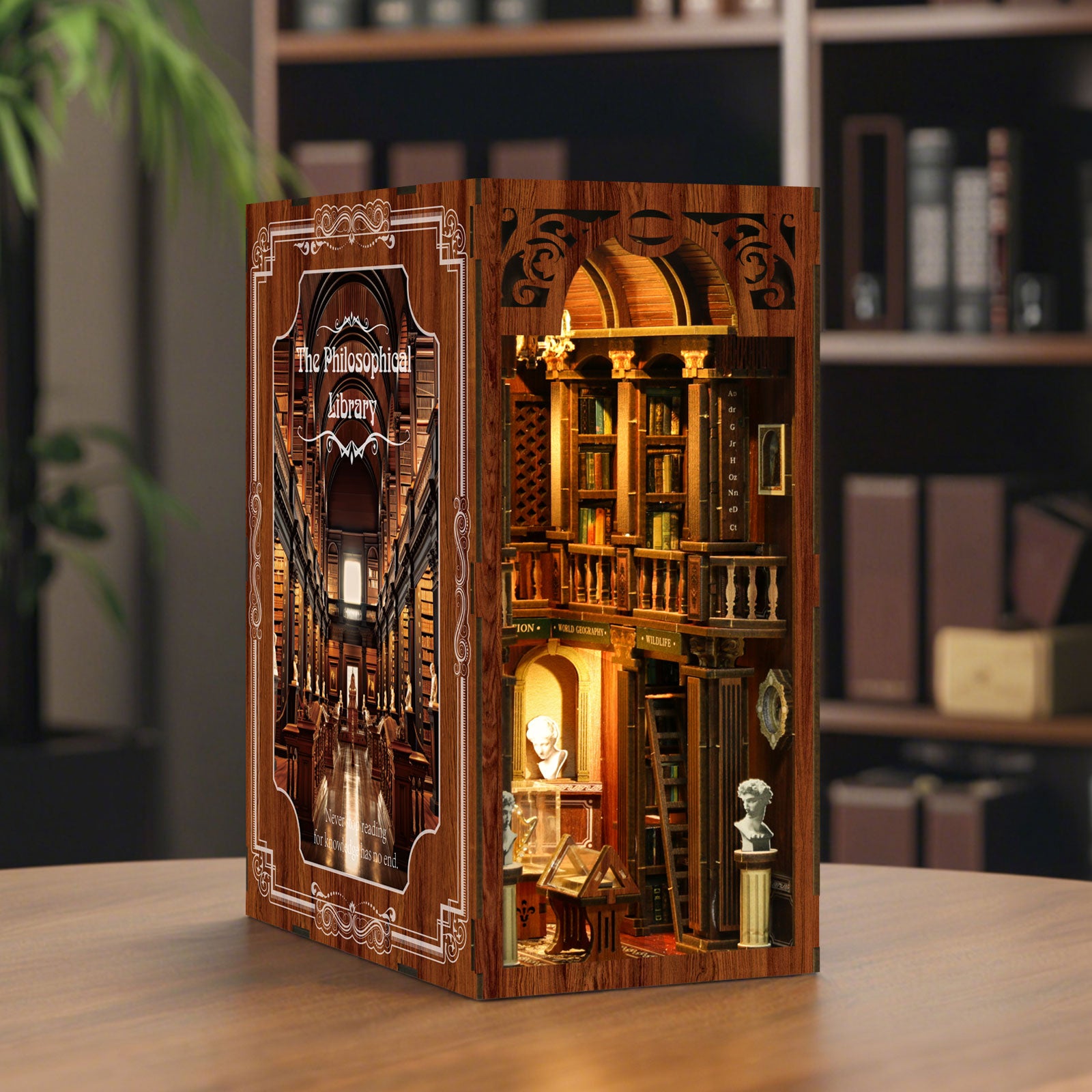 Wooden DIY book nook kit standing on tabletop with illuminated multi-level interior