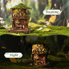 Mini treehouse diorama with warm interior lights and green moss base